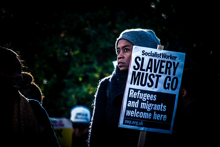 A protester displays a placard that reads "Slavery must go" during the demonstration. 
In response to the slave trade in Libya, African Lives Matter held a national march in London on December 9th. Protesters marched until the front the Libyan Embassy in Knightsbridge.
(EDITORS NOTE: Image was altered with digital filters.)