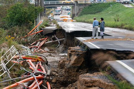 Local residents walk on a collapsed road following the Typhoon Hagibis.
The death toll rises to 48, two days after Typhoon Hagibis passed through Japan while 15 are still missing and more than 100 injured as thousands of troops are deployed on rescue missions across the country.