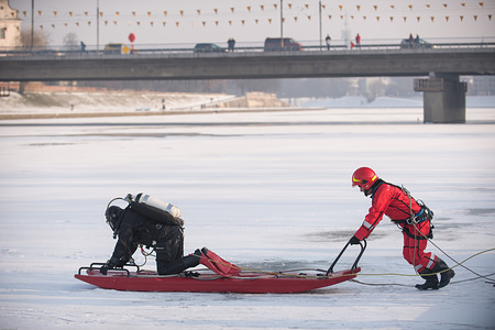 A diver prepares to rescue a man who has fallen into Vistula river while walking on the ice in Krakow.
A man fallen to the frozen river as his own weight broken the thin ice as he was walking on the surface, rescue services rushed to save him and he is currently being treated at the hospital.