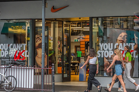 Women walk into a Nike store seen on Chapel street, one of the most popular shopping and entertainment streets in Melbourne.