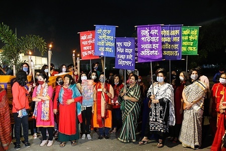 Protesters holding torches and placards expressing their opinion, during the procession.
Students, female activists, teachers and journalists took part in a torch procession demanding women's safety and protest against the violence towards women in Dhaka.