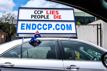 A Falun Dafa or Falun Gong follower seen promoting anti-Chinese Communist Party (CCP) movement through a display board on his vehicle reading "ENDCCP.COM" in Melbourne.
