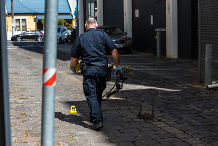 Police officer from Crime Investigation unit inspects a crime scene in Windsor/Prahran area where extensive blood trails were marked and pictured
A man was found with severe injuries on his hands and after a police investigation it was found to be a "medical incident" where the injuries were self-inflicted police reports.