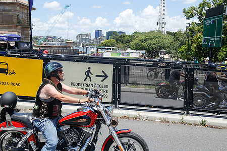 A member of the Indigenous Riders Club rides towards the Cultural Centre Busway Station during the demonstration.
Crowds of people gathered in Brisbane, Queensland to protest against the Australia public holiday, which is a date synonymous with the beginning of many decades of persecution of Indigenous Australian people by the British colonialists. The protesters instead referred to the date as Invasion Day, to signify the invasion of Aboriginal lands by British colonisers, beginning with the First Fleet in 1788. Many policies stem from the harsh early days such as overwhelming incarceration of Aboriginal people, as well as many deaths in custody and the destruction of cultural heritage sites. A march was organised through the Brisbane central business district from Queens Gardens to Musgrave Park in South Brisbane.