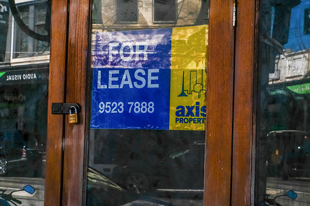 Blue and yellow sign for lease in a former restaurant venue on Chapel Street precinct.