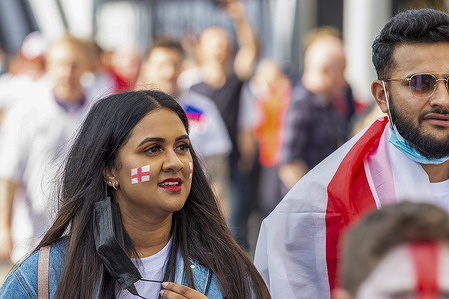 A fan with face paint arrives at Wembley Stadium ahead of the England v Denmark UEFA Euro 2020 semi-finals.