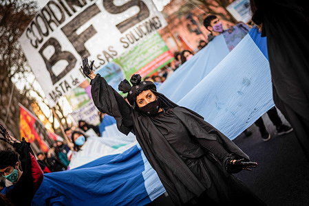 A protestor shows her oil smudged hand during the protest march in Ciudad Aute Buenos Aires.Groups of environmental activists marched towards Plaza de Mayo to demand that oil companies not continue to settle in Argentine territory.