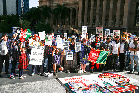 Protesters hold placards during the demonstration.The Refugee Action Collective organized a rally in Brisbane’s King George Square to call for more assistance for people escaping Taliban rule in Afghanistan, as well as more permanent visas, an end to the ban on UNHCR-recognized refugees entering via Indonesia and family reunion rights.
