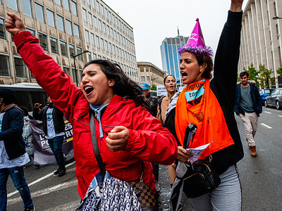 Two women from the Middle East are seen shouting slogans during the demonstration.
Sans-papiers (without papers), an organization that represents and advocates for undocumented migrants in Belgium, planned a march in Brussels, as part of a broader campaign called “We are Belgium, too.” Thousands of people demonstrated to demand that a national regulatory commission should be established in regards to undocumented migration, and calls for the integration of undocumented migrants into the Belgian rule of law.