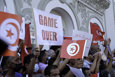 A demonstrator is seen holding a placard reading "game over" during a rally at the Habib Bourguiba Avenue in Tunis.Thousands rally in support of President Kais Saied after he suspended the legislature, sacked the government and seized control of the judiciary, later moving to rule by decree.