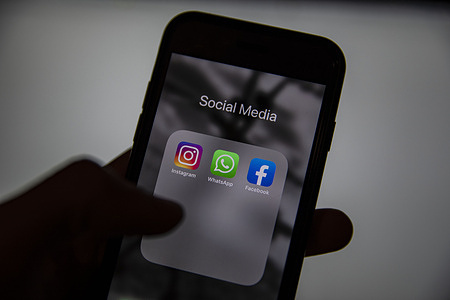 In this photo illustration, Instagram, Whatsapp, and facebook logos are seen displayed on a smart phone screen.