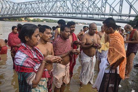 Hindu devotees are seen performing rituals at ganga ghat on Mahalaya.
Mahalaya marks the start of the Durga Puja festival and the end of Pitru Paksha however this year the much awaited Durga Puja festival will be held a month after Mahalaya. This is the 16th - lunar day period in Hindu calendar when Hindus pay homage to their ancestors.