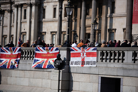 Protestors display banners and flags at Trafalgar Square during the march.
Protesters marched from Trafalgar Square to UK Parliament protesting the Northern Ireland Protocol in London, demanding its cancellation.