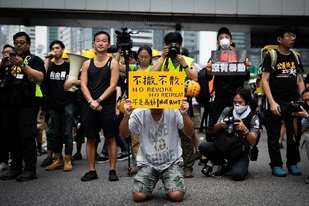 A protester holds a placard while kneeling down on the ground during the demonstration.
Numerous and massive protests broke out in Hong Kong in 2019, as the extradition bill raising serious concerns as Hong Kong authorities can pass non-sentence defendant back to China, this was known as one of the biggest civil outcries after the handover of Hong Kong to China in 1997. Protests soon escalated from peaceful demonstrations into violent clashes with the police in July. Thousands arrested, injured and now-behind-bars, as the main wave of clashes come to an end in November during the sieges in Universities. June 2020, authorities passed the National Security Law to eliminate any possible unrest in this semi-autonomous city.