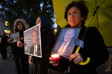 Supporters of the National Council of Resistance of Iran (NCRI) hold up pictures and candles to pay tribute toSir David Amess who was fatally stabbed several times last week while holding a constituency surgery in Leigh on Sea, Essex.
Anglo-Iranian community members held a memorial service and vigil outside the Parliament to pay tribute to the murdered MP Sir David Amess.