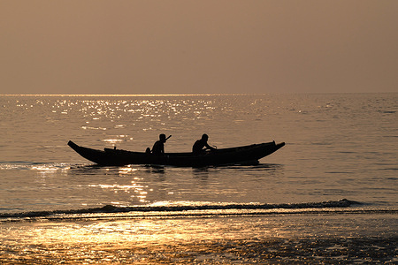 Fishermen return back home after fishing in the evening at Kuakata beach in Patuakhali District of Bangladesh.
Kuakata is one of the rare natural spots that offers a full view of the rising and setting sun over the Bay of Bengal. A popular tourist destination, it is about 320 kilometers South from Dhaka, the capital city of Bangladesh.