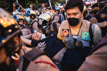 Riot police and medic carry a pro-democracy protester who is unconscious during the demonstration.
Pro-democracy protesters gathered at Din Daeng police station after Warit Somnoi a 15 year old protester who was shot in the head outside Din Daeng police station during the demonstration and died two months later. Protesters believe that the bullets came from the police station due to the bullet hole on the wall.