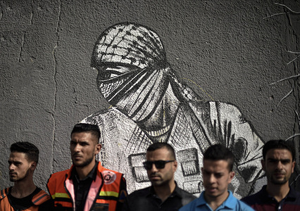 Palestinians pose next to a mural protesting the 104th anniversary of the British Balfour Declaration on the southern Gaza Strip.
The Balfour Declaration issued by British Foreign Secretary, Lord Arthur James Balfour in November 1917 "a national home for the Jewish people" in Palestine.