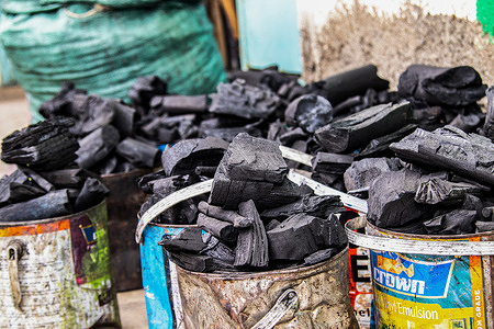 A view of charcoal packed in the tins ready for sale in Nakuru.
Trees capture carbon dioxide from the atmosphere and convert it into biomass through the process of photosynthesis. Uncontrolled felling of trees to make charcoal is contributing to deforestation and this could impact negatively on the environment. People who cannot afford alternative clean energy opt for charcoal, otherwise known as polluting energy as their main source of cooking fuel. In the ongoing climate change conference in Glasgow, world leaders have pledged to end deforestation by 2030, highlighting the role forests play in decarbonization.