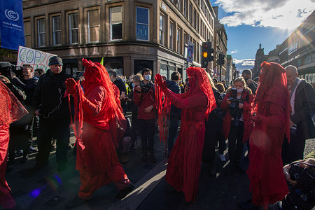 Members of the Red Rebel Brigade seen during the protest.As the UN Climate Change Conference (26th Conference of the Parties (COP26)) continues, Extinction Rebellion and other climate change activist groups have held a rally at Glasgow Royal Concert Hall steps, Buchanan Street, and are marching through the streets of Glasgow city centre.