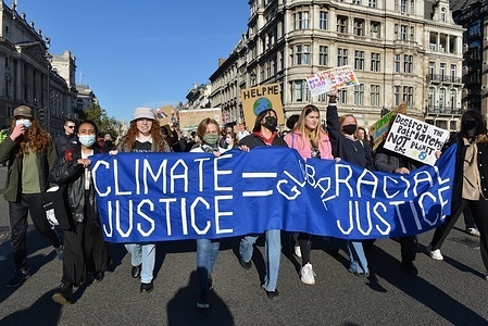 Demonstrators hold a banner while marching along Whitehall during the protest.
Young climate protesters gathered opposite Downing Street and marched to Parliament Square to demonstrate the government's lack of climate action.