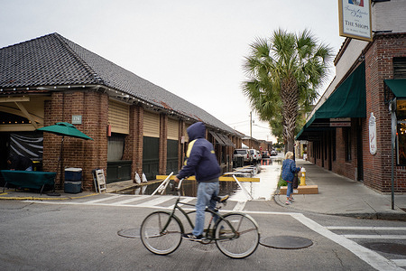 A portion of S. Market Street is blocked off due to flooding adjacent to Charleston's Historic City Market. Parts of downtown Charleston endured a second day of flooding. The combination of an offshore storm system and an unusually high king tide resulted in several road closures throughout the region. The city is weighing the costs of implementing a new sea wall to combat the increasing problem of flooding.