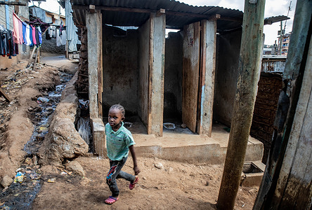 A young girl walks past abandoned toilets in Kibera Slums.
World Toilet Day is an official United Nations international observance day on 19 November to inspire action to tackle the global sanitation crisis Worldwide. This is always set as a reminder of proper sanitation and the importance of having a toilet across our local neighborhoods to avoid the spreading and contracting of diseases amongst ourselves and also protect our waters and climate against pollution from the disposal of flying toilet bags.