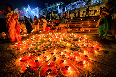Indian Hindu devotees light Lamps while praying to God on the eve of dev Deepavali.
Dev Deepavali is the biggest Light Festival of India where devotees decorate the river bank of Ganges with millions of Lamps as part of the festival.