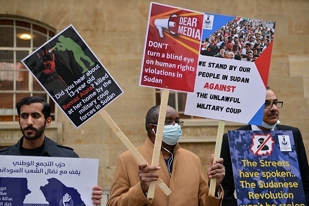 A protester holds placards during the demonstration.
Protesters gathered opposite the BBC Broadcasting House in Portland Place in solidarity with the people of Sudan, and against the military coup.