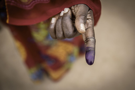 A woman shows off her ink-stained finger after voting during the presidential elections.
This is the first presidential election in Gambia since the long-standing dictator Yahya Jammeh was ousted from power in 2017.