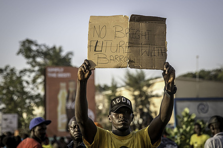 A supporter of the opposition United Democratic Party (UDP) holds a placard during the protest.Supporters of the opposition United Democratic Party (UDP) protest against the Gambia's presidential election results, which have been rejected by their candidate Ousainou Darboe. Incumbent Adama Barrow was returned for a second term with a resounding win.