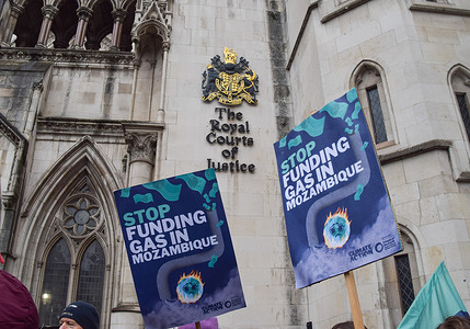 'Stop Funding Gas in Mozambique' placards are seen during the demonstration.
Protesters gathered outside the Royal Courts Of Justice where environmental campaign organisation, Friends Of The Earth have begun their legal case against the UK government's funding of a major gas project in Mozambique, which will have a huge environmental and climate impact.