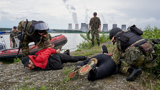 OMON (riot police) are seen detaining violators during a training exercise at a reservoir near the nuclear power plant.
The special forces of the National Guard regularly conduct a training exercise where some of their officers act as the riot police and some as criminals. They made this activity to prepare its members for possible criminal situations that will happen in the area.