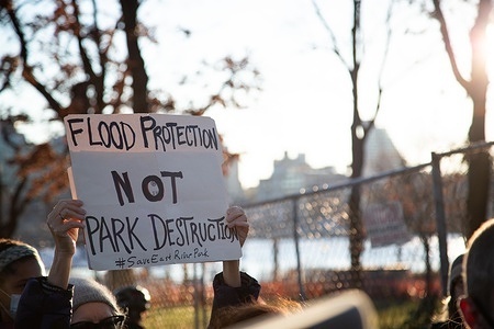 A protester holding a placard reading, "Flood protection not park destruction." during the demonstration.
Several park defenders are arrested as they protested after delivering a copy of the Temporary Restraining Order to police at the East River Park amphitheatre.