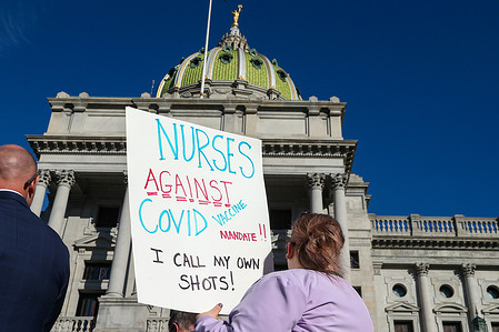 A protester holds a placard that says "Nurses against covid vaccine mandate, I call my own shots" during a rally against vaccination mandates held at the Pennsylvania State Capitol.
Protesters gathered on the steps of the Pennsylvania State Capitol to protest against covid-19 vaccination mandates.