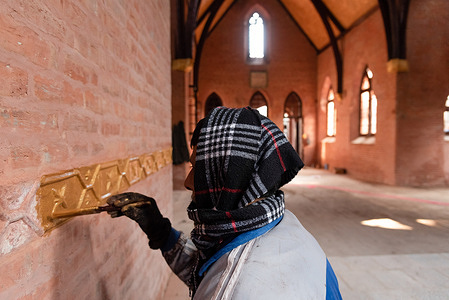 A labourer seen painting inside Saint Luke's Church premises in Srinagar.
Only a week to Christmas, the century-old St Luke's Church at Dalgate in Srinagar is a busy site, as Kashmiri labourers put finishing touches to its renovation. The heritage church that was abandoned for over five decades will reopen its doors for prayers on Christmas day. It is being repaired as part of the government of Jammu and Kashmir's "Preservation and Maintenance of Architecture and Heritage" program.