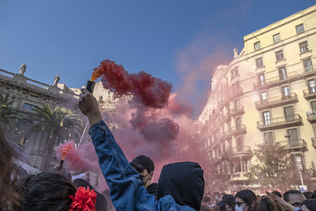 A student seen holding a red smoke bomb during the demonstration.
High school students have demonstrated in the center of Barcelona the commercialization of public education and against the reform of the Law of the Spanish minister Manuel Castells.
