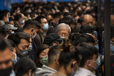 Commuters wearing facemasks are seen waiting for a subway train to arrive at a MTR station in Hong Kong. 
The city of Hong Kong is on high alert as a heavily-mutated new Covid-19 variant known as the Omicron variant has been detected from a passenger traveling from South Africa.