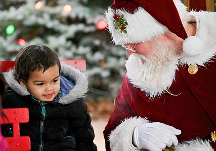 Santa talks with a young visitor about his wish list.
A man dressed as Santa Claus rode around town on a fire truck visiting children while observing social distancing rules.