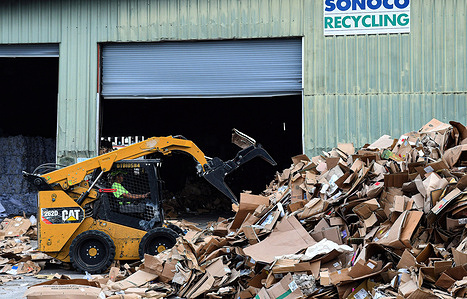 A worker moves scrap cardboard at a recycling facility.
Cardboard recycling rates have been volatile due to changes in trade flows, with net exports of cardboard to China affected by the country's import restrictions.