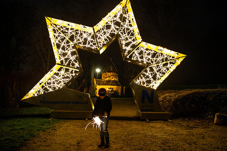 A little boy is seen playing with a sparkler in front of one of the lit sculptures.
On the same day that Prime Minister Rutte announced a strict lockdown in the Netherlands, in order to prevent the rapid advance of the Omicron variant, for the second year in a row, eight impressive lit sculptures have been placed around the city center of Nijmegen to cheer the people up. The new measures will remain in effect until January 14th.