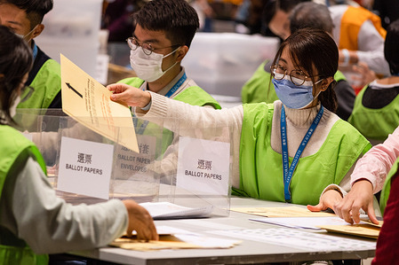 Polling officials count votes from the Election Committee Subsector.
The 2021 Legislative Council General Election was held on December 19, with a 30.2 percent turnout rate, the lowest since 1997. This is the first major legislative council election since the electoral system was reformed, following a major crackdown on pro-democratic parties and the passing of the Hong Kong National Security Law, which introduced a Candidate Eligibility Review Committee to ensure only pro-Beijing candidates were allowed to stand. Pro-China and pro-establishment candidates won a sweeping victory.