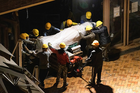 The upper-half of the Pillar of Shame seen being moved by the workers for later transportation.
Authorities in Hong Kong tore down a public sculpture dedicated to the victims of the Tiananmen Square massacre, accelerating a campaign to erase the crackdown from public recollection and stamp out dissent in a city that until recently was one of Asia’s freest.
The 26-foot-tall artwork, known as the “Pillar of Shame,” had stood at the University of Hong Kong for nearly a quarter-century and honored the hundreds, if not thousands, of students and others killed on June 4, 1989, when the Chinese military crushed pro-democracy protests.