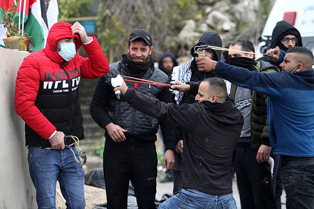 Palestinian protesters seen shooting stones at Israeli soldiers with slingshots, during the demonstration.
Palestinians protested the rebuilding of the Jewish settlement of Homesh, which was evacuated in 2007. Israeli settlers destroyed Palestinian villages, homes and cars during the protest in the village of Burqa.