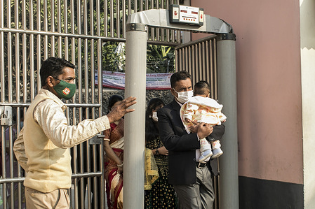 A Christian Devotee carrying a kid arrives for prayers at a Holy Rosary Catholic Church during Christmas.
Bangladesh celebrates Christmas Day, the birthday of Jesus Christ, but due to the Covid-19 pandemic this year, the day will be celebrated on a limited scale, maintaining health safety rules, including maintaining social distancing and wearing masks everywhere.