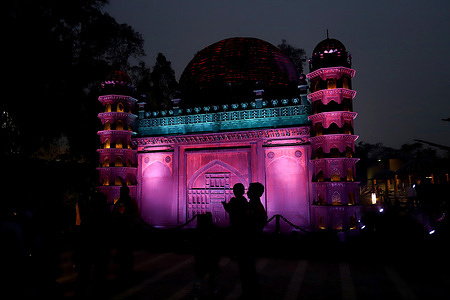 Visitors take pictures of a replica of Gol Gumbaz at Bharat Darshan Park in New Delhi.The park has replicas of several iconic monuments of India built with scrap and waste material.