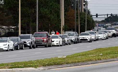 Cars line up near a COVID-19 testing site at the South Orange Youth Sports Complex in Orlando. Due to the extreme demand for testing as a result of the spread of the Omicron variant, the county opened this site today in addition to two other existing sites which have reached capacity on a daily basis, forcing them to close early.