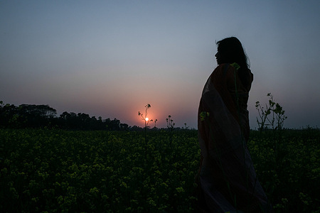 A woman poses for a photo at a Mustard Field at the outskirts of Dhaka.
Mustard is a cool weather flower, which is grown from seeds and sown in early spring. From mid December through to the end of January, Bangladesh farmers cultivate their crops of bright yellow mustard flowers until it fully blooms.