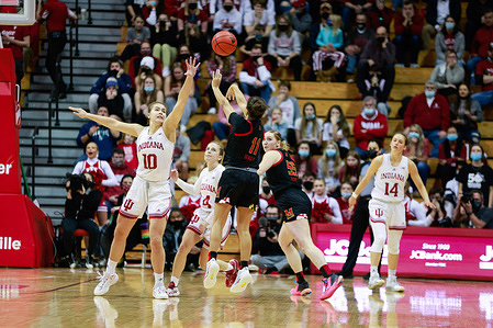 Indiana Hoosiers forward Aleksa Gulbe (No.10) defends against Maryland Terrapins guard Katie Benzan (No.11) during the National Collegiate Athletic Association (NCAA) women's basketball game in Bloomington. 
Indiana University beat Maryland 70-63 in overtime.