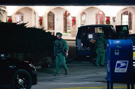 Members of the Critical Incident Response Team (CIRT) leave after arresting a homeless man who barricaded himself in a hotel room at the Indiana Memorial Union building at Indiana University.
Police were dispatched after Cecil L. Gilbert, a homeless, refused to leave the hotel room and told police he had an AK-47. Finally, after several hours Gilbert was taken into custody around 2 a.m. The police said that Gilbert has a long criminal history.
